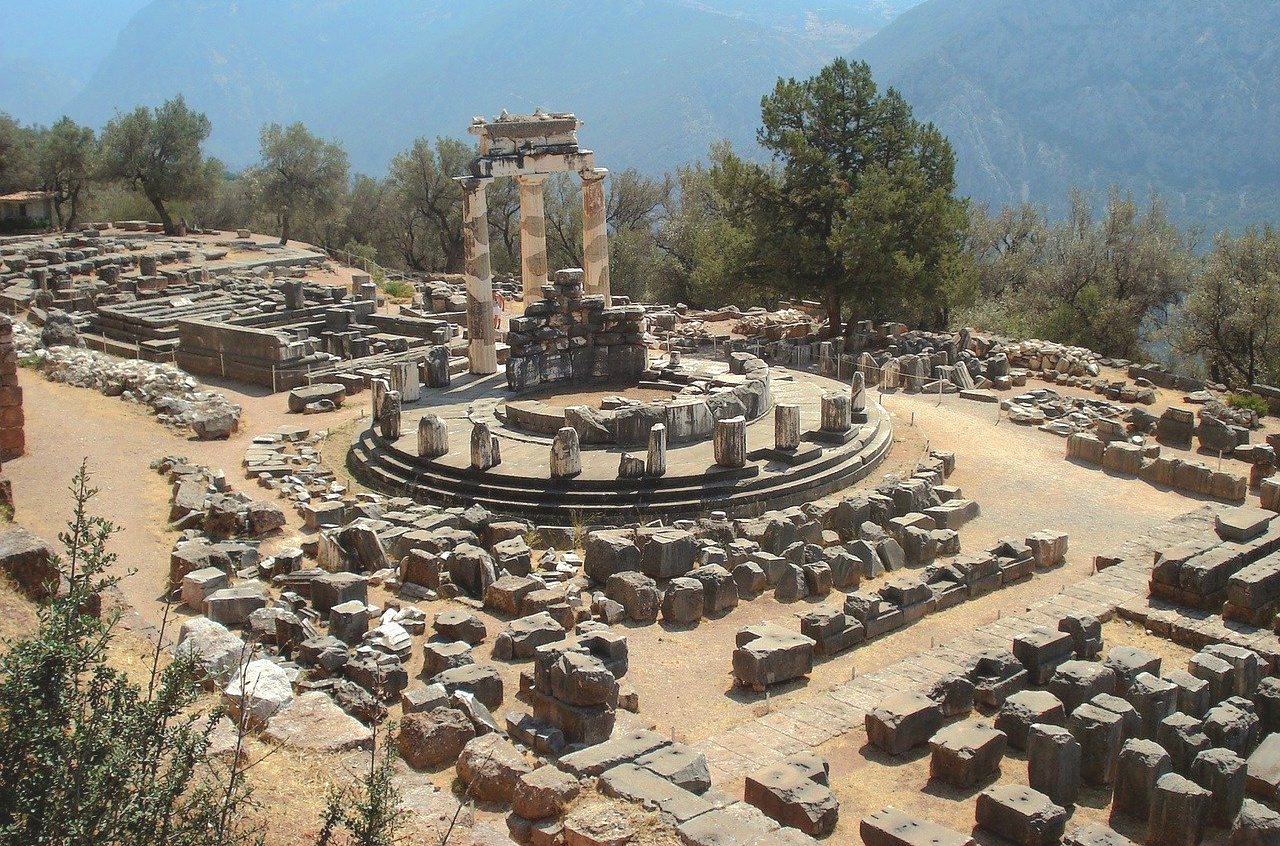 12 stone column bases, 3 restored full columns in a circle on a stand.