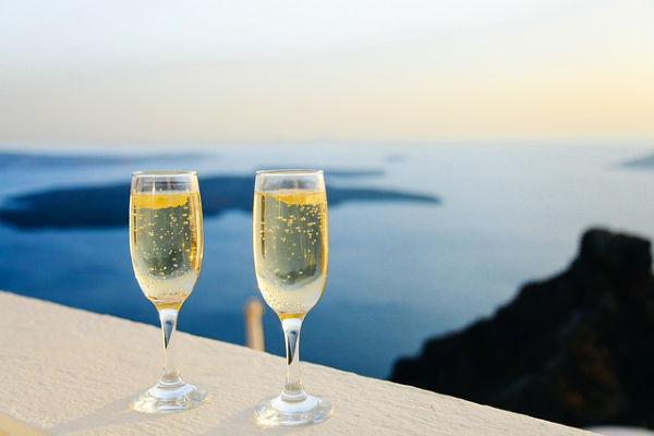 champagne glasses overlooking the sea