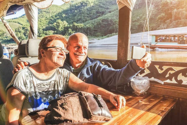 Happy older couple visiting Southeast Asia on a small group tour