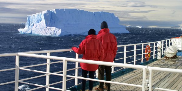 Older couple looking at iceberg on National Geographic Expeditions cruise