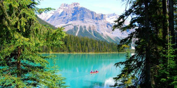 Red canoe on bright blue lake in Canada national park