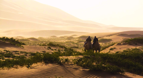 Two men on camels on silk road