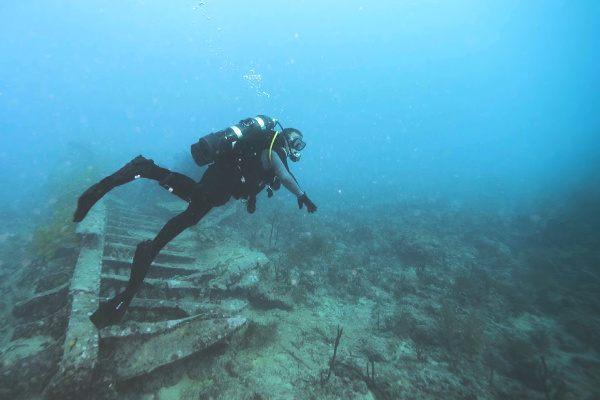 Diver next to stone stairs