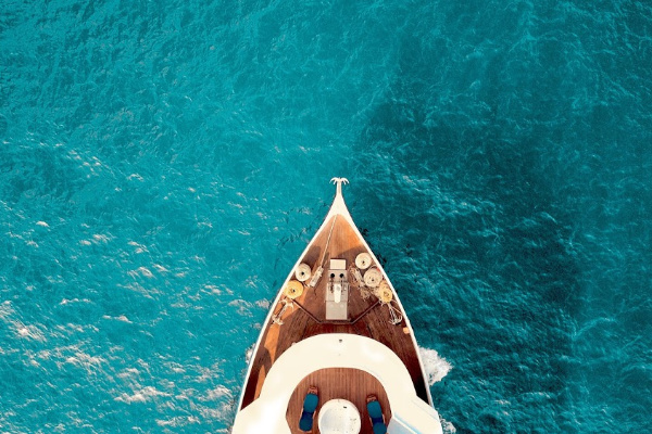 A drone shot of a boat in the blue ocean 