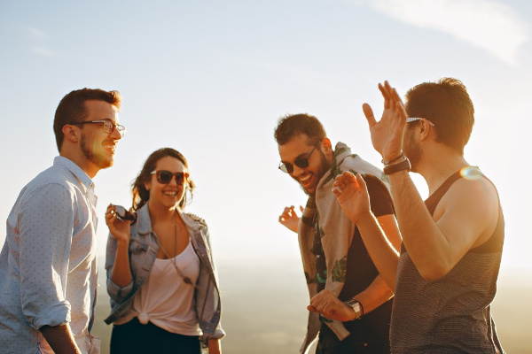 four friends talking and laughing