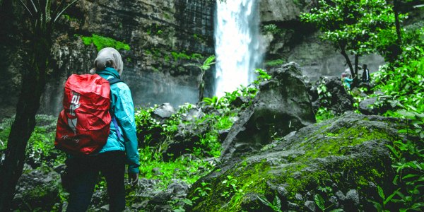 Young traveler hiking in Iceland to Waterfall