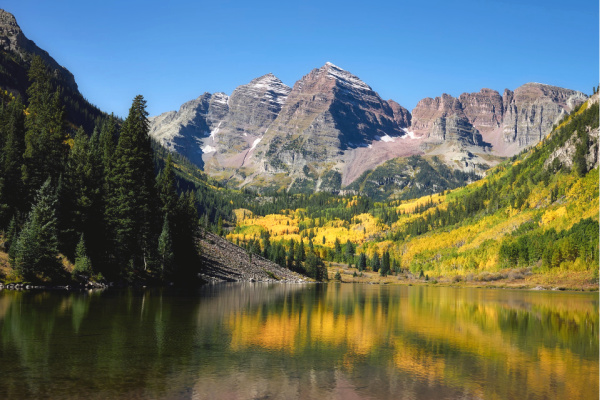 Maroon Bells mountain surrounded by Colorado Aspens in Fall