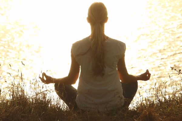 Woman meditating on yoga retreat