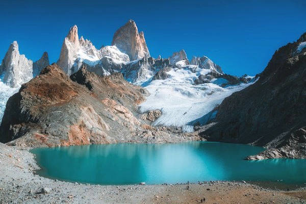 Patagonian snowy mountains and lake in the daytime