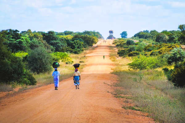 Women walking on dusty road in Mozambique