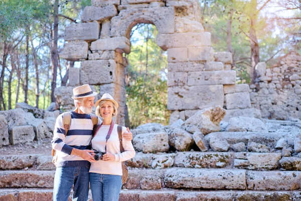 Older couple on adventurous trip among ruins in Asia