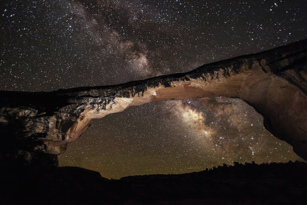 Natural bridge against starry night sky in Utah