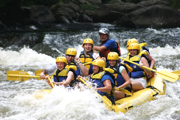 a group of people whitewater rafting 