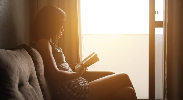 Girl reading in window