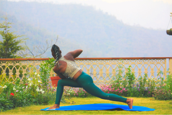 Young woman in yoga post at an ashram