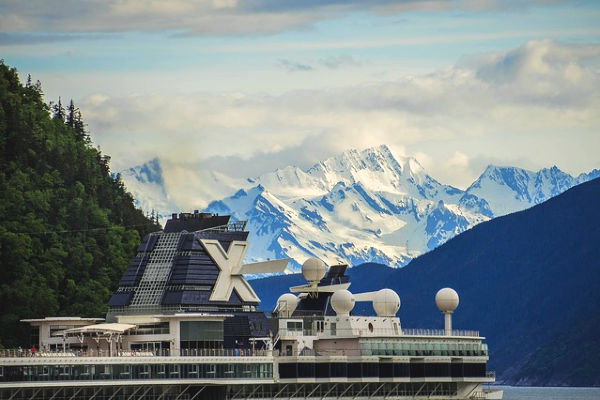 A cruise ship in Alaska overlooking snowcapped mountains