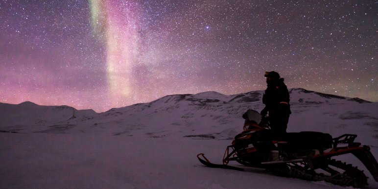 Snowmobile to see Northern Lights in the Arctic