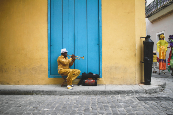 Solo musician in doorway in cuba