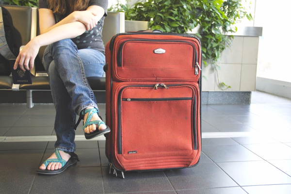 Young traveler with one suitcase in airport