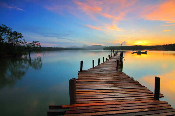 Sunrise over pier and lake