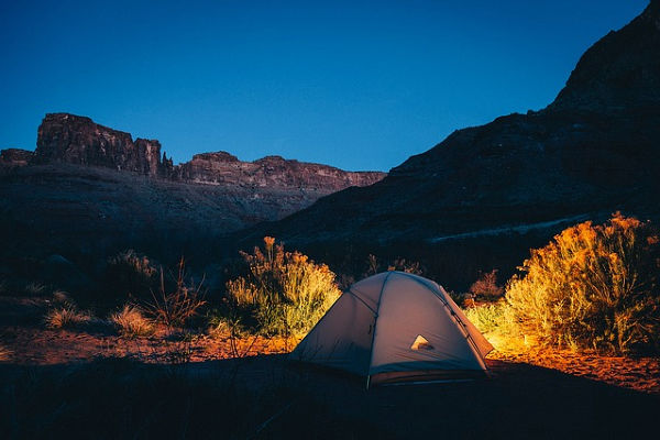 a tent in the mountains at night