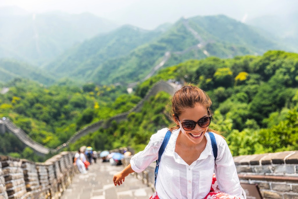 Young woman climbing the Great Wall of China