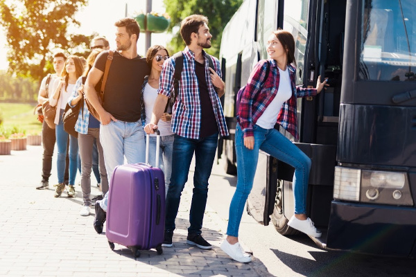 Group of tourists getting on a bus tour