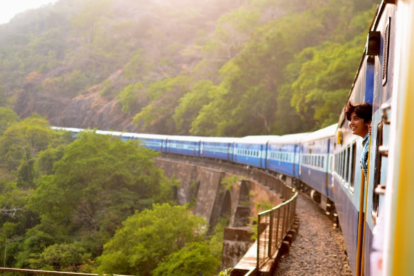 A girl peaking her head out from a train