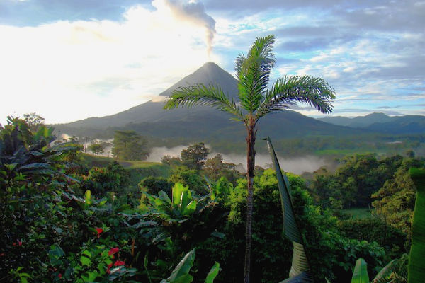 view of the costa rica jungle and an active volcano