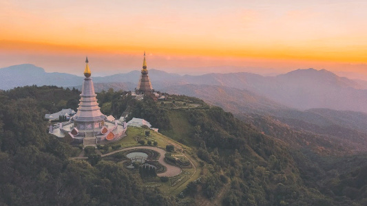 sunset over temples in thailand