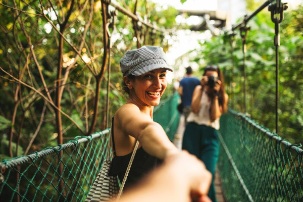 Young traveler in rainforest with small tour group