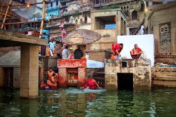 Women in traditional red dress along the Ganges River in India