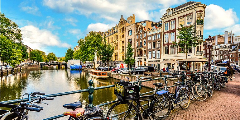 Biking along canals in Amsterdam