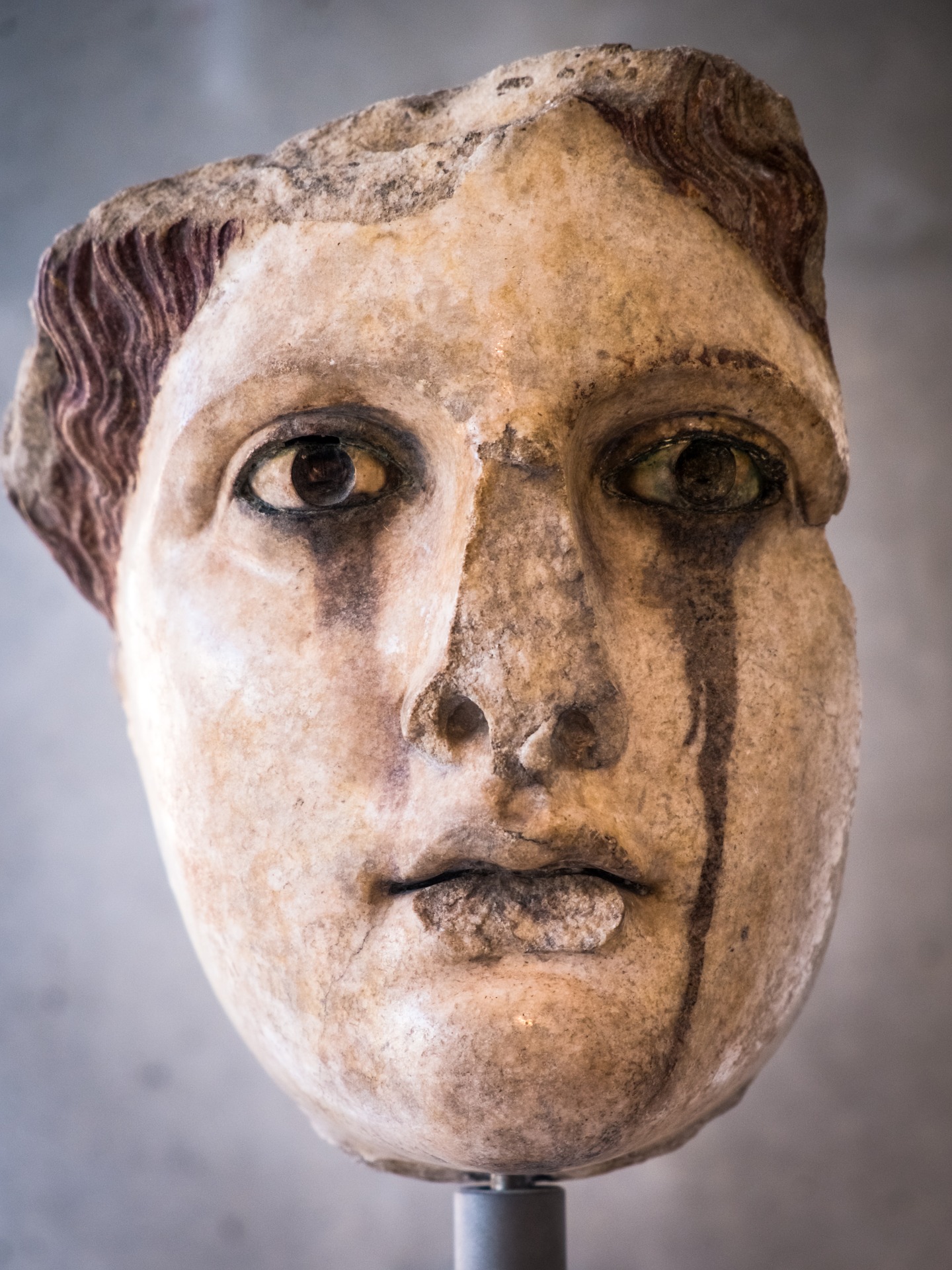 Ancient bust, brown stone, open eyes, curly hair