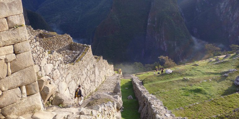 Tourist exploring ruins of Machu Picchu, Peru