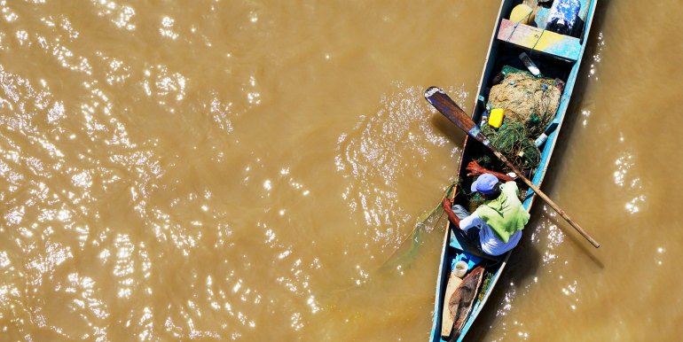 Boat on brown water in the Amazon
