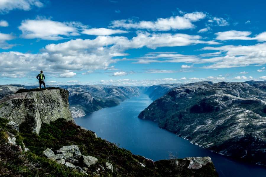 man-overlooking-norwegian-fjord