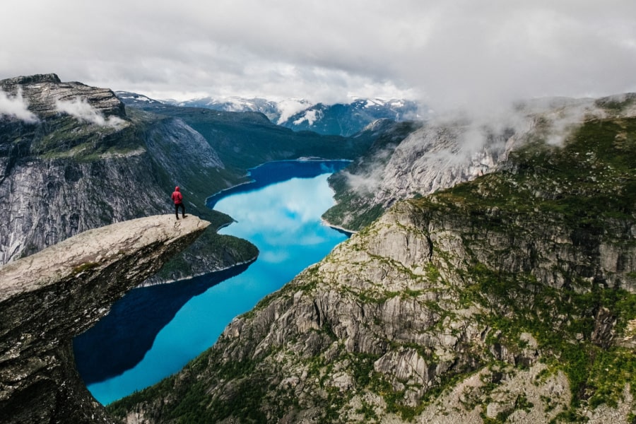 man-overlooking-norwegian-fjord