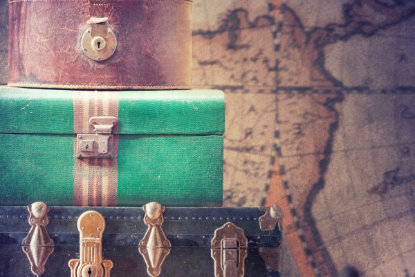 Old fashioned suitcases with world map