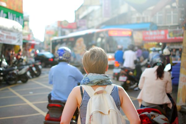 solo female traveler with backpack traveling around the world