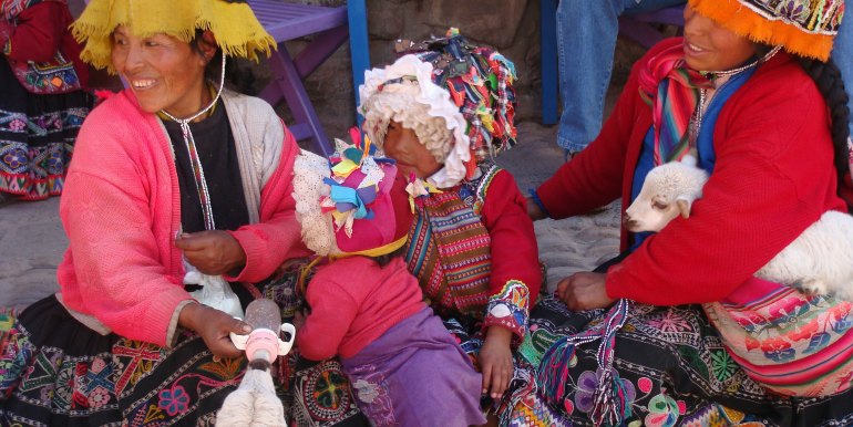 Two women and child in traditional dress, Peru