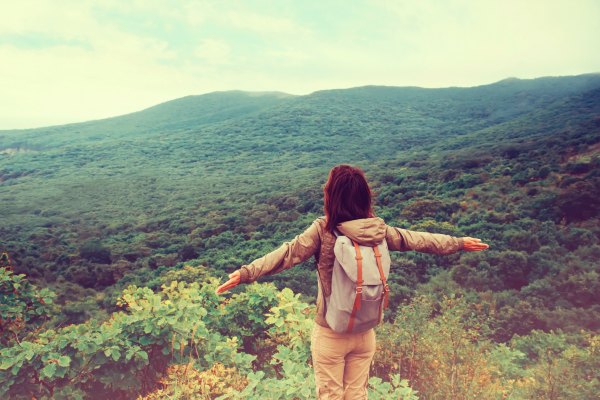 Young female traveler on hike in the mountains